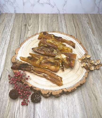 paddywack dog treats on a wooden plate