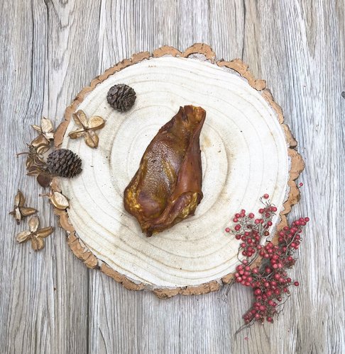 a pig's ear dog treat on a wooden plate